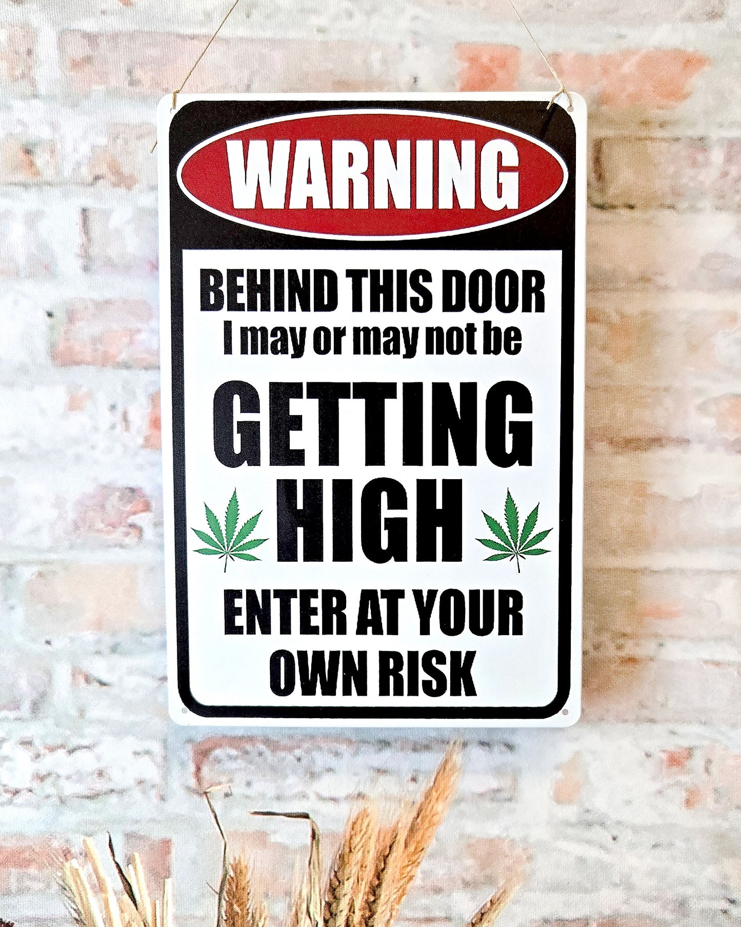 close up of weed wall décor metal sign that says warning behind this door i may or may not be getting high enter at your own risk