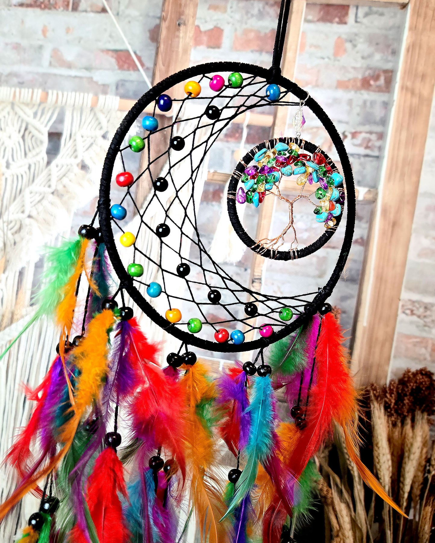close up of multi color tree of life feather dream catcher