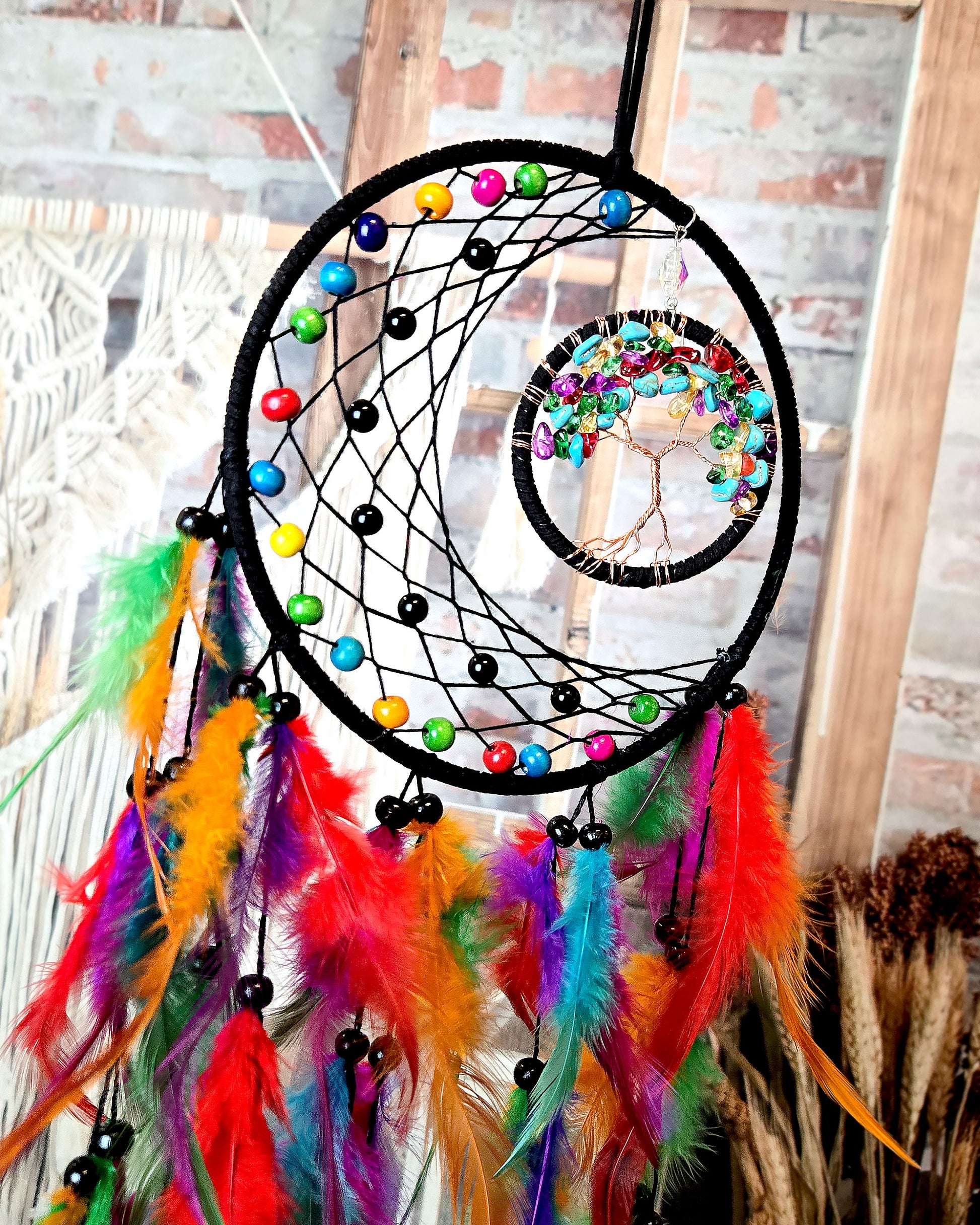 close up of multi color tree of life feather dream catcher