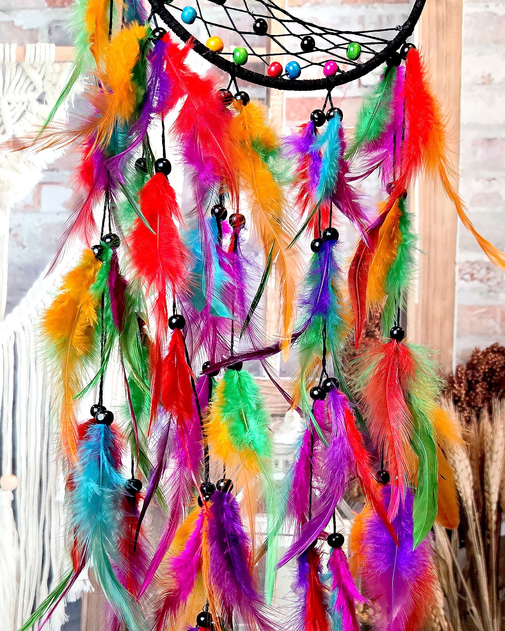 close up of feathers on multi color tree of life dream catcher