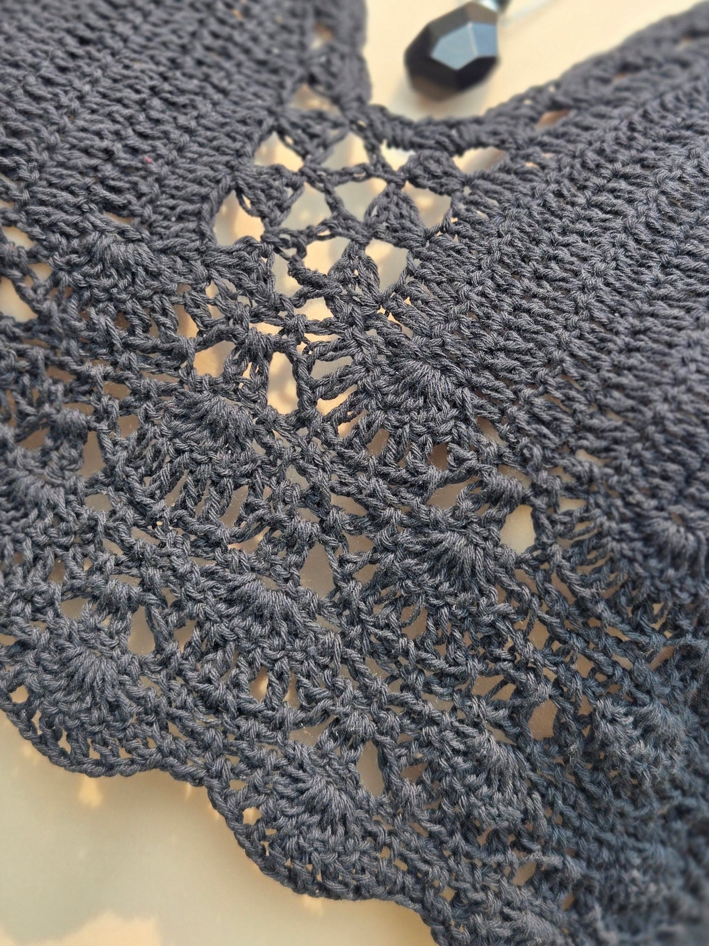 Close-up of a black crochet halter top with intricate details