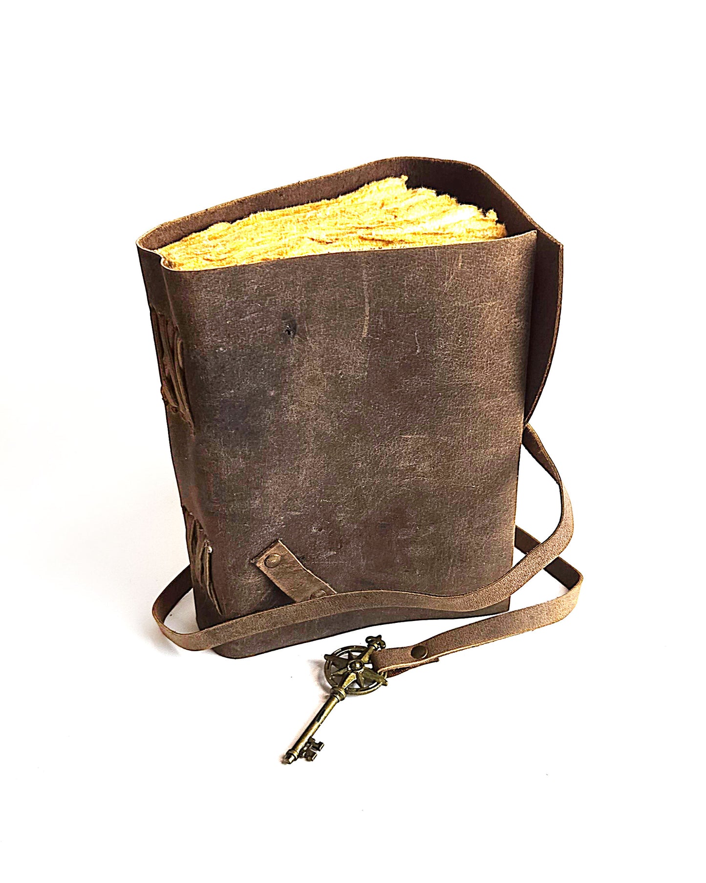 leather journal with a leather strap with decorative antique key closure and deckle edge vintage look paper top front