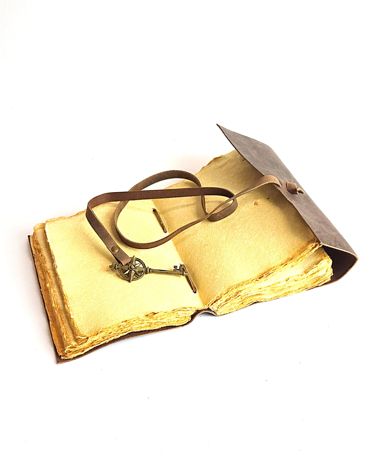 leather journal with a leather strap with decorative antique key closure and deckle edge vintage look paper inside view