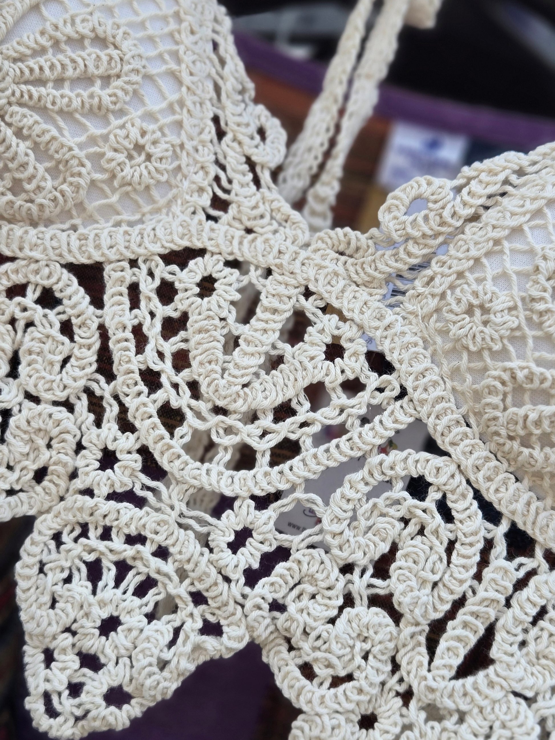 Close-up of a crochet halter top with a blurred background