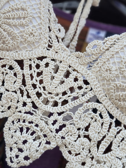 Close-up of a crochet halter top with a blurred background