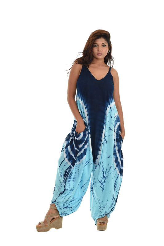 Woman wearing a blue and white tie-dye jumpsuit on a white background