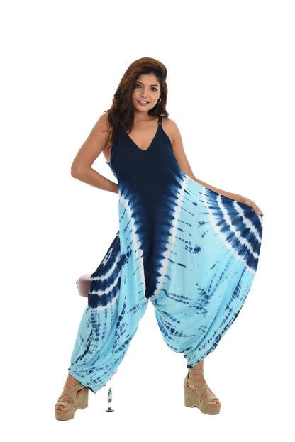 Woman wearing a blue and white tie-dye jumpsuit on a white background