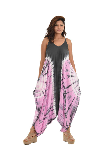 Woman wearing a tie-dye jumpsuit with a gradient from gray to pink on a white background