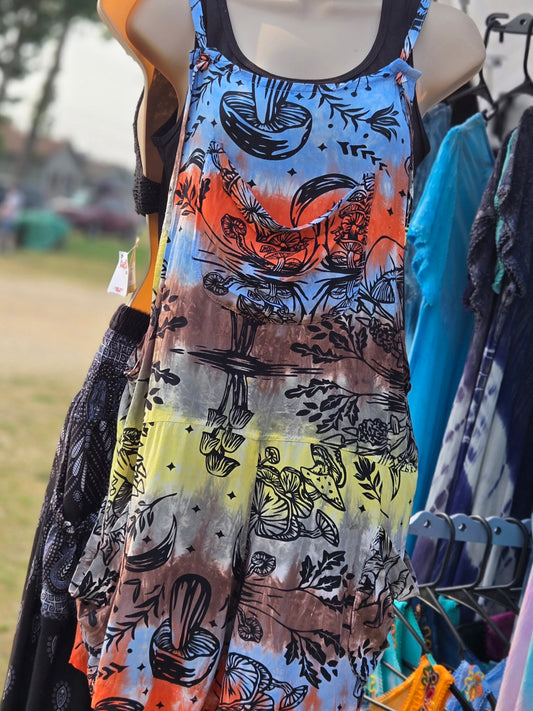 Colorful shortalls with mushroom print on a mannequin against a blurred outdoor background