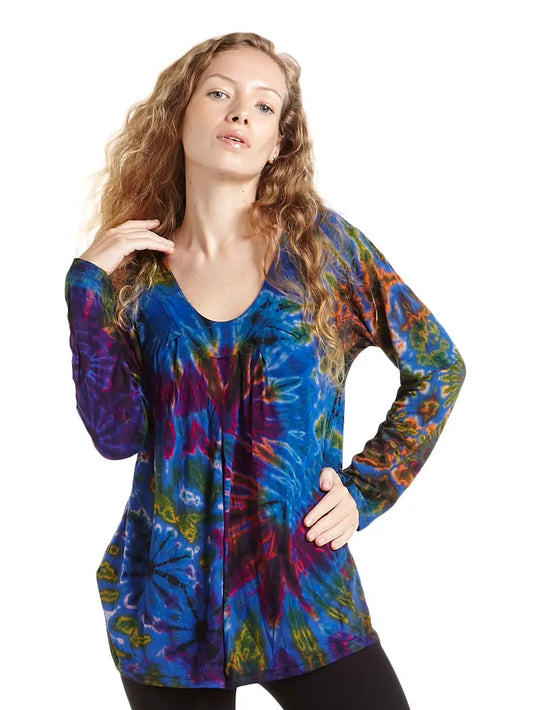Woman wearing a colorful tie-dye long-sleeve top on a white background