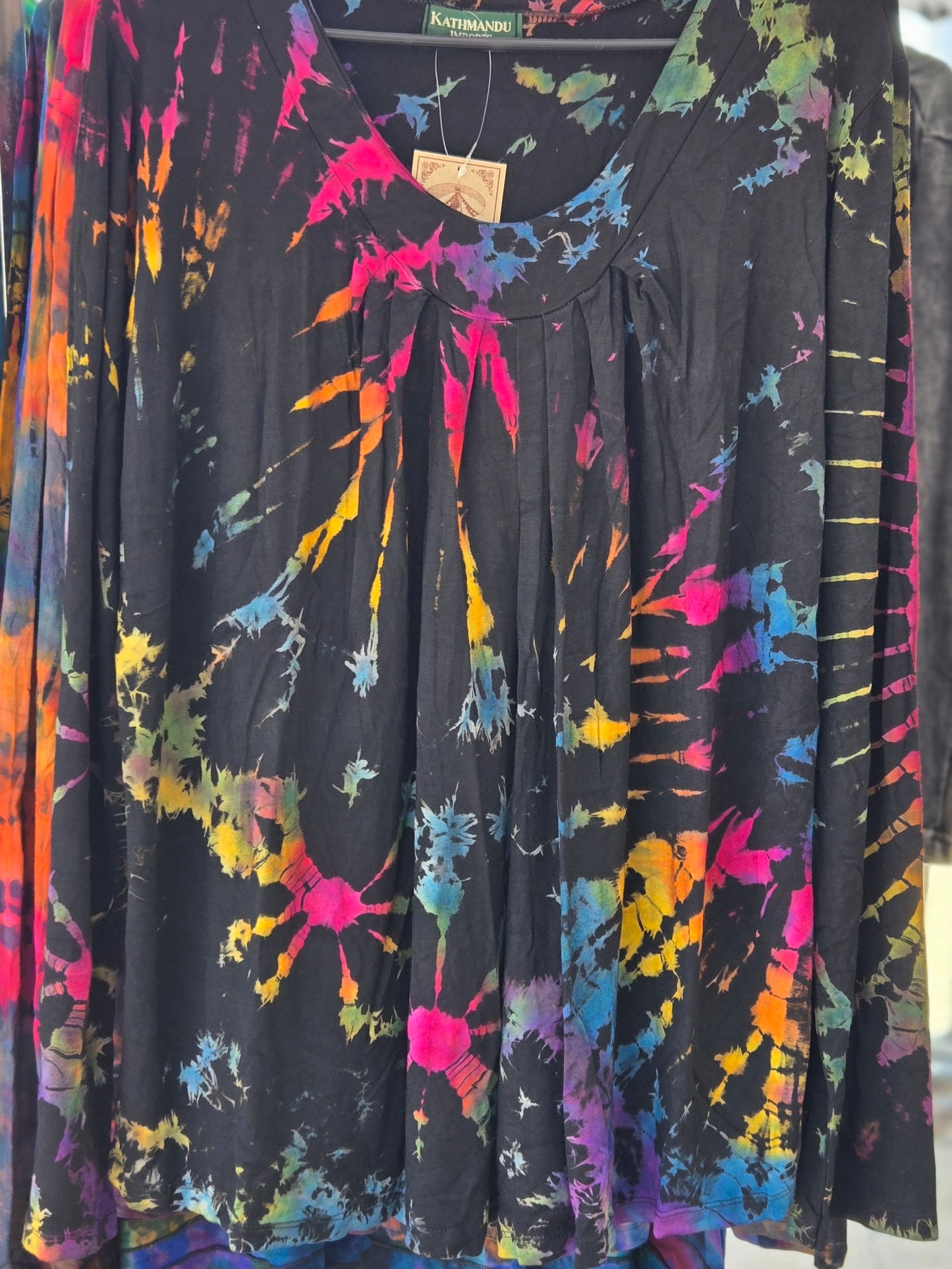 Colorful tie-dye shirt on a hanger.