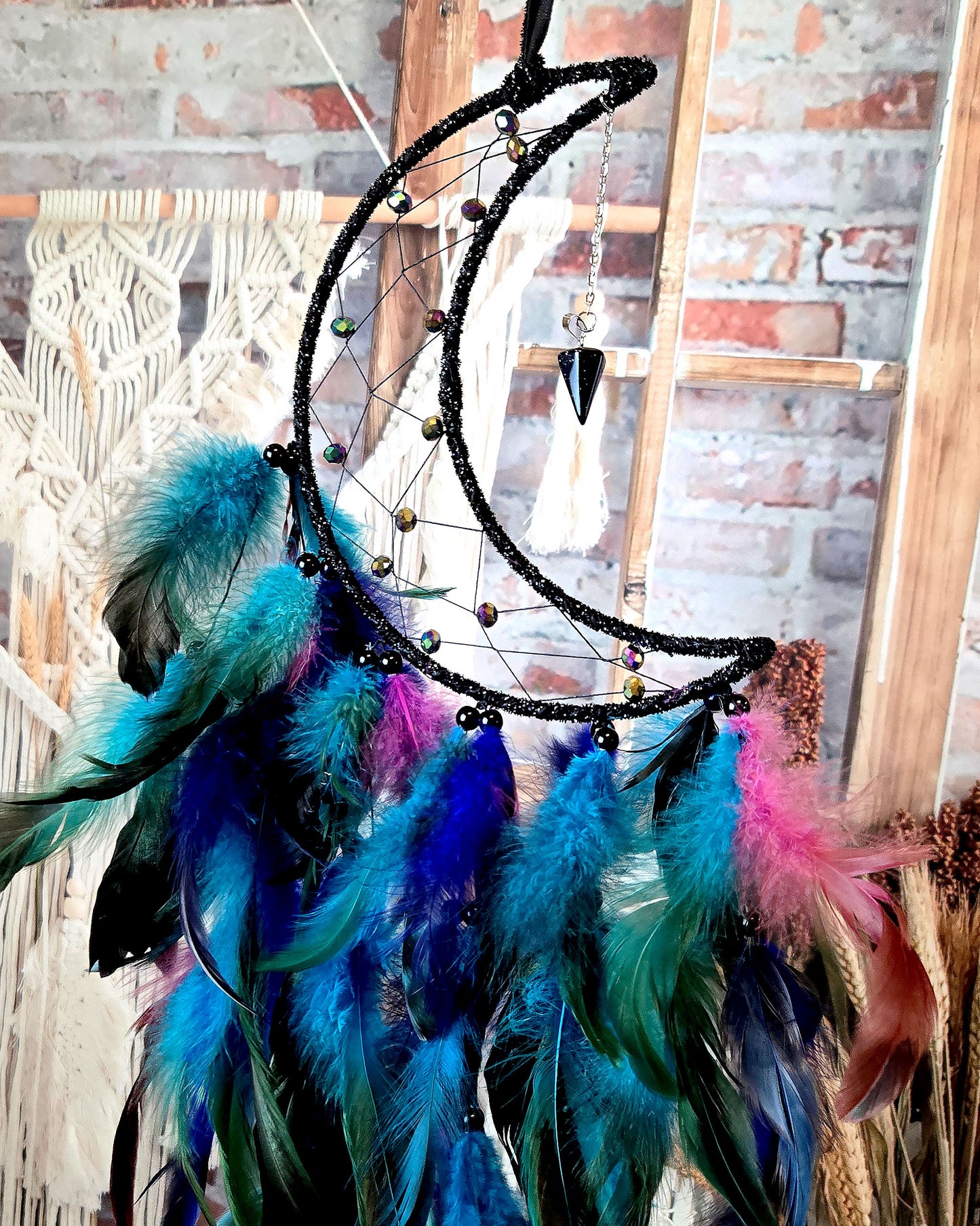 boho home décor black and blue crescent moon dream catcher with feathers close up