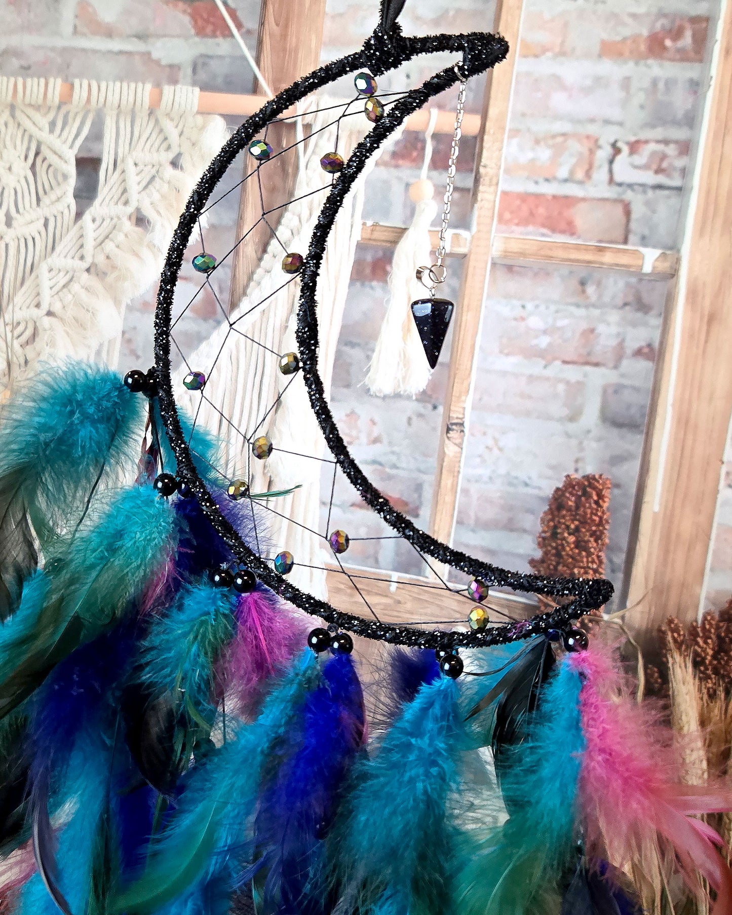 hippie home décor black and blue crescent moon dream catcher with feathers close up