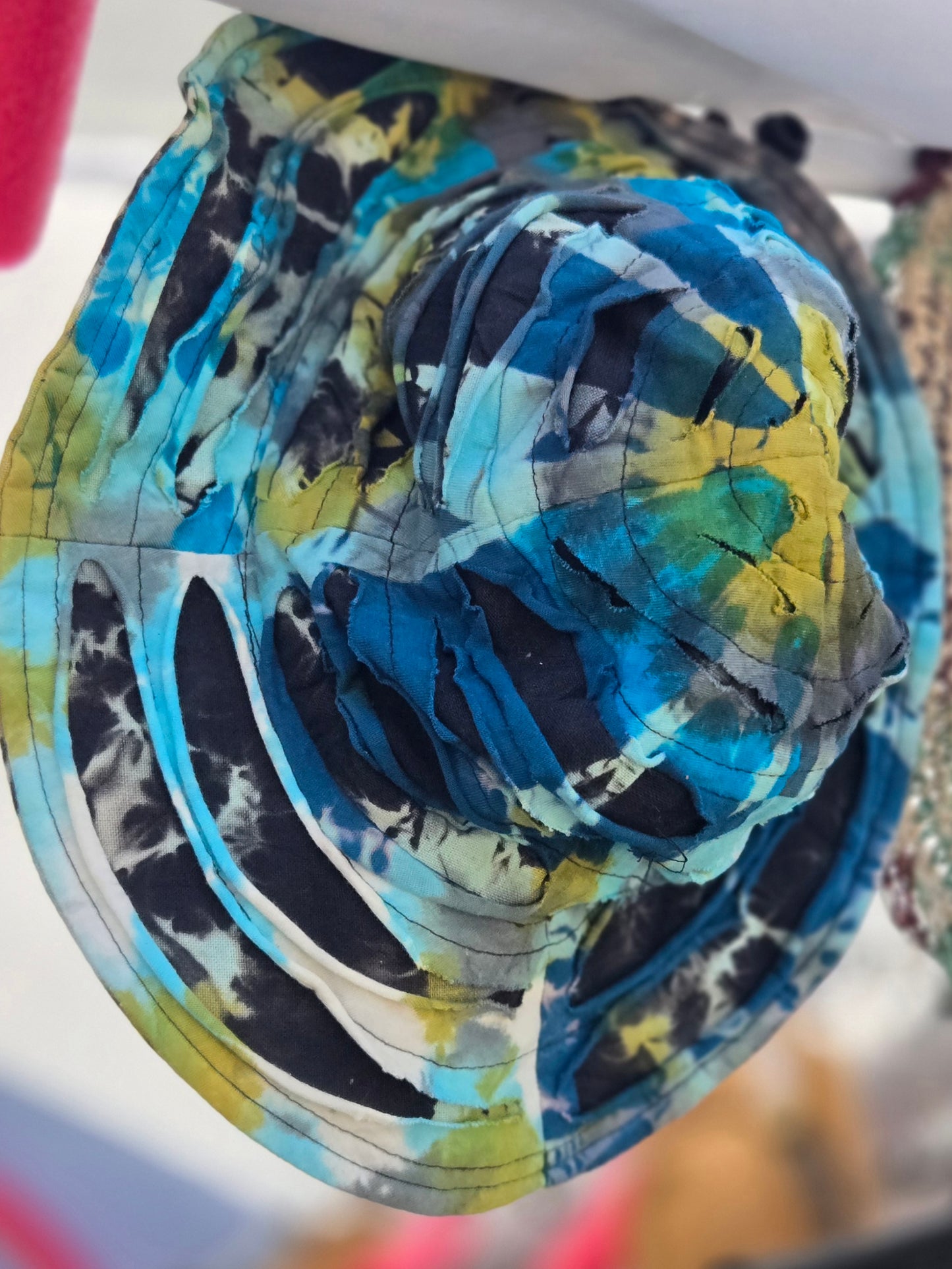 Colorful tie-dye patterned bucket hat with a blurred background