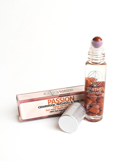 organic essential oil blend roll on of cedarwood patchouli and rose with red jasper crystals showing red jasper roller ball