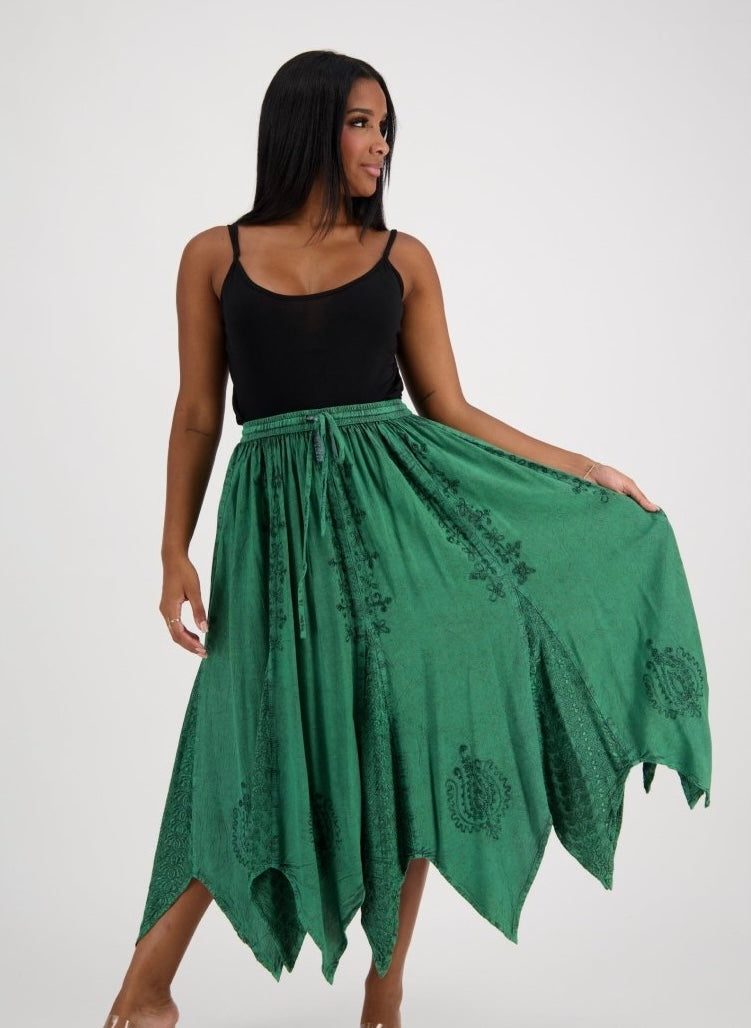 Woman wearing a green skirt with a black top on a white background