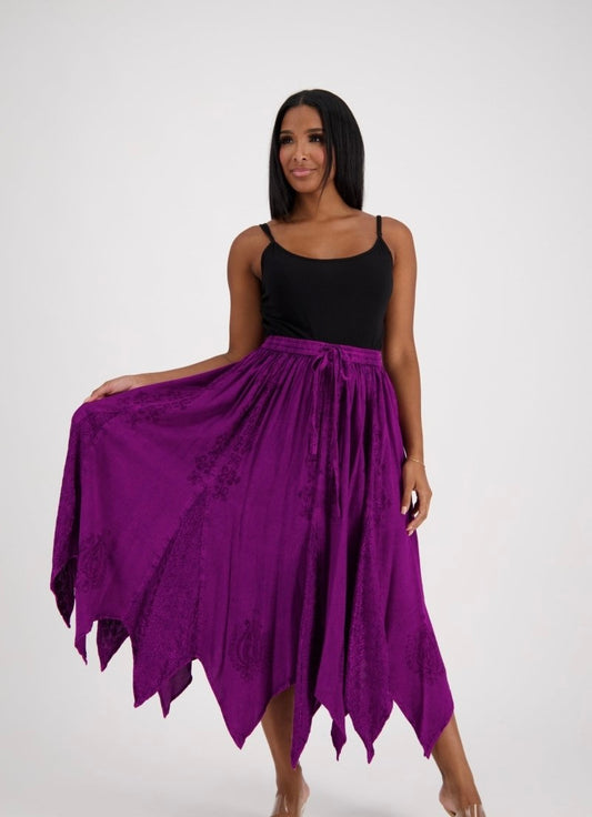 Woman wearing a black top and purple fairy skirt on a white background