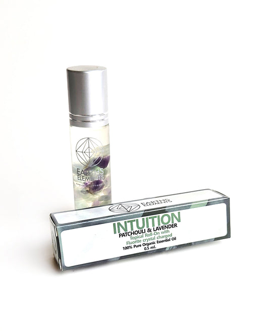 organic essential oil blend roll on of patchouli and lavender with fluorite crystals
