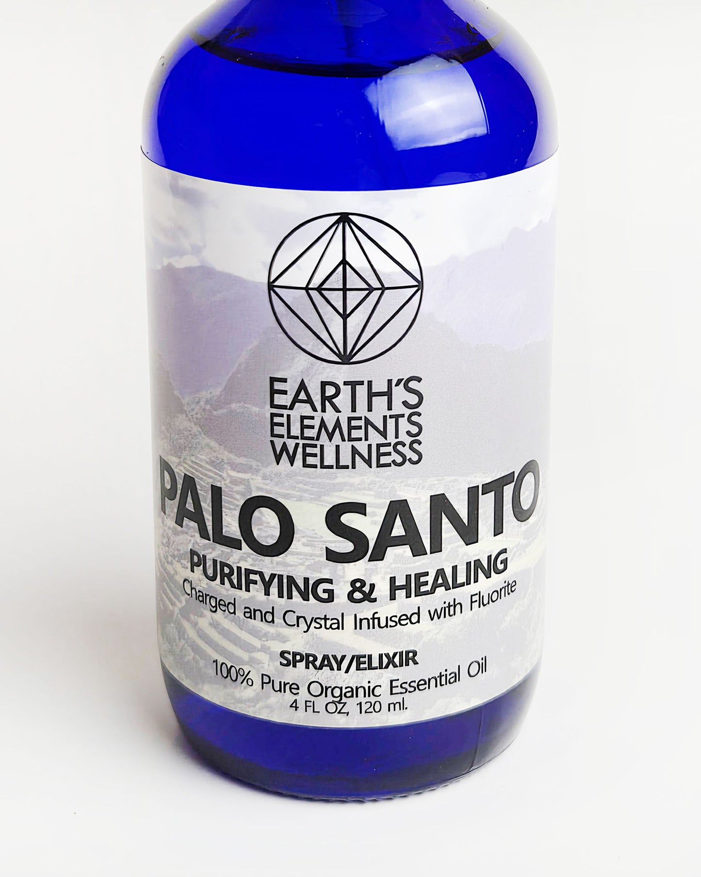 Palo Santo essential oil spray with fluorite crystals close up