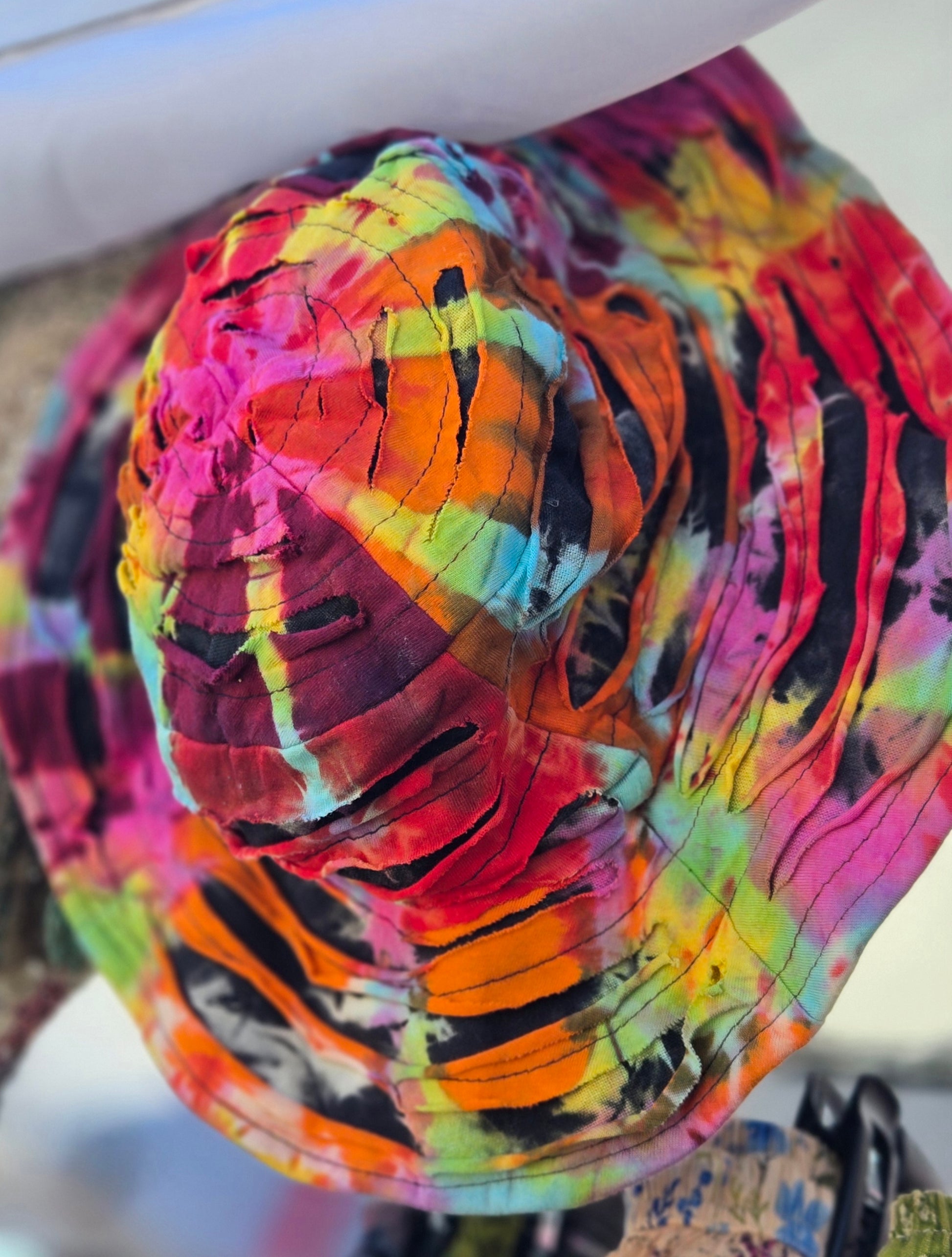 Colorful tie-dye patterned bucket hat with a blurred background