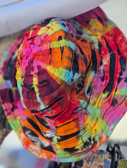 Colorful tie-dye patterned bucket hat with a blurred background