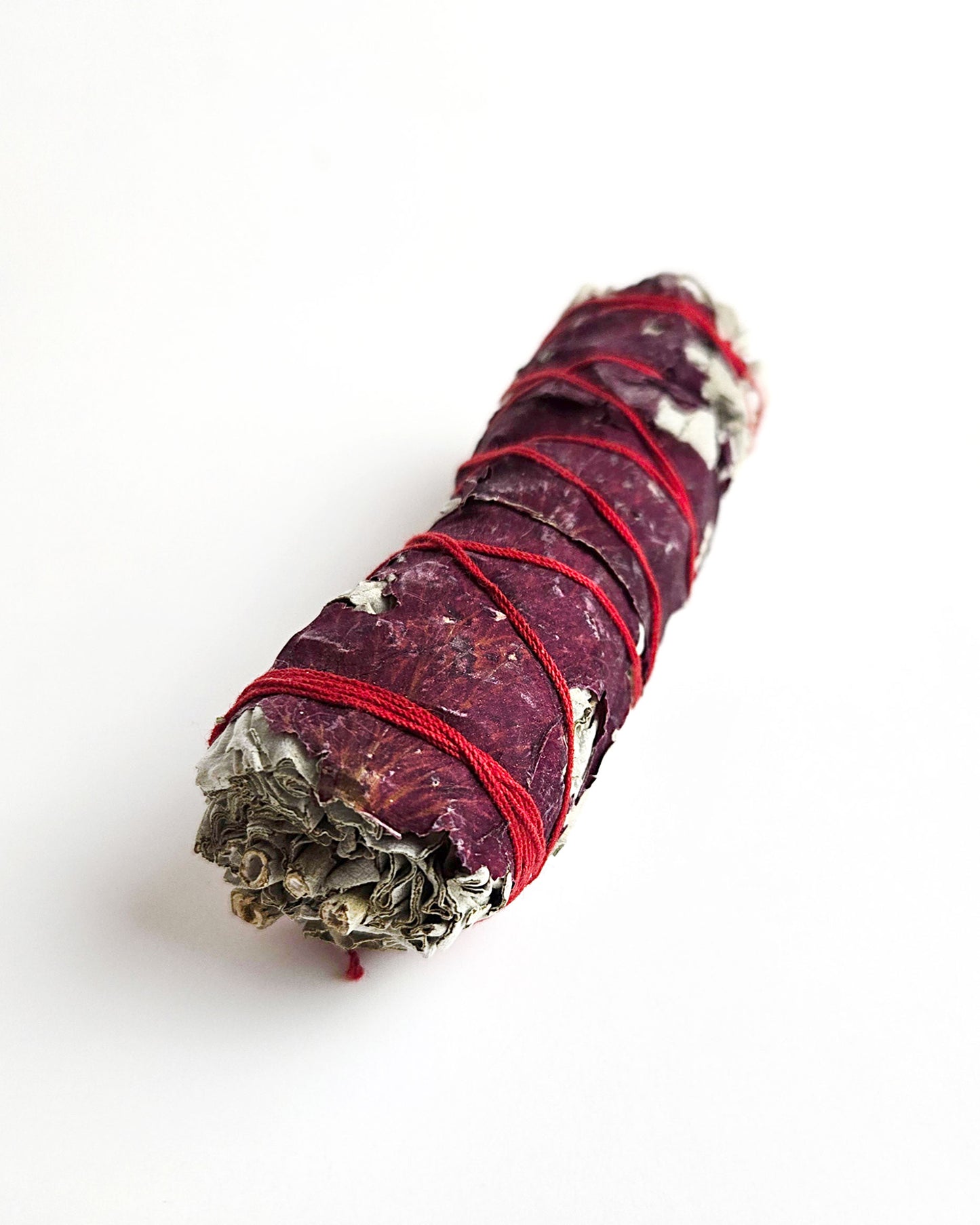 sage smudge stick with red rose petals for smudging and cleansing