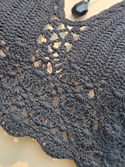 Close-up of a black crochet halter top with intricate details