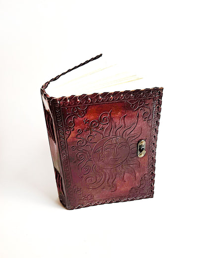 leather journal with embossed sun and moon design antique buckle closure and leather stitched edges top front