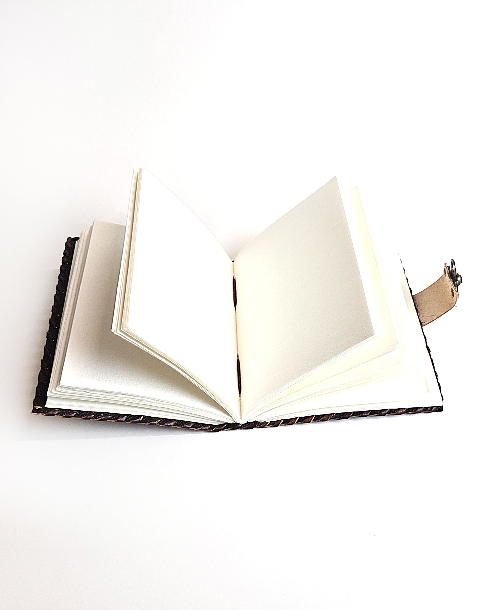leather journal with embossed sun and moon design antique buckle closure and leather stitched edges inside view