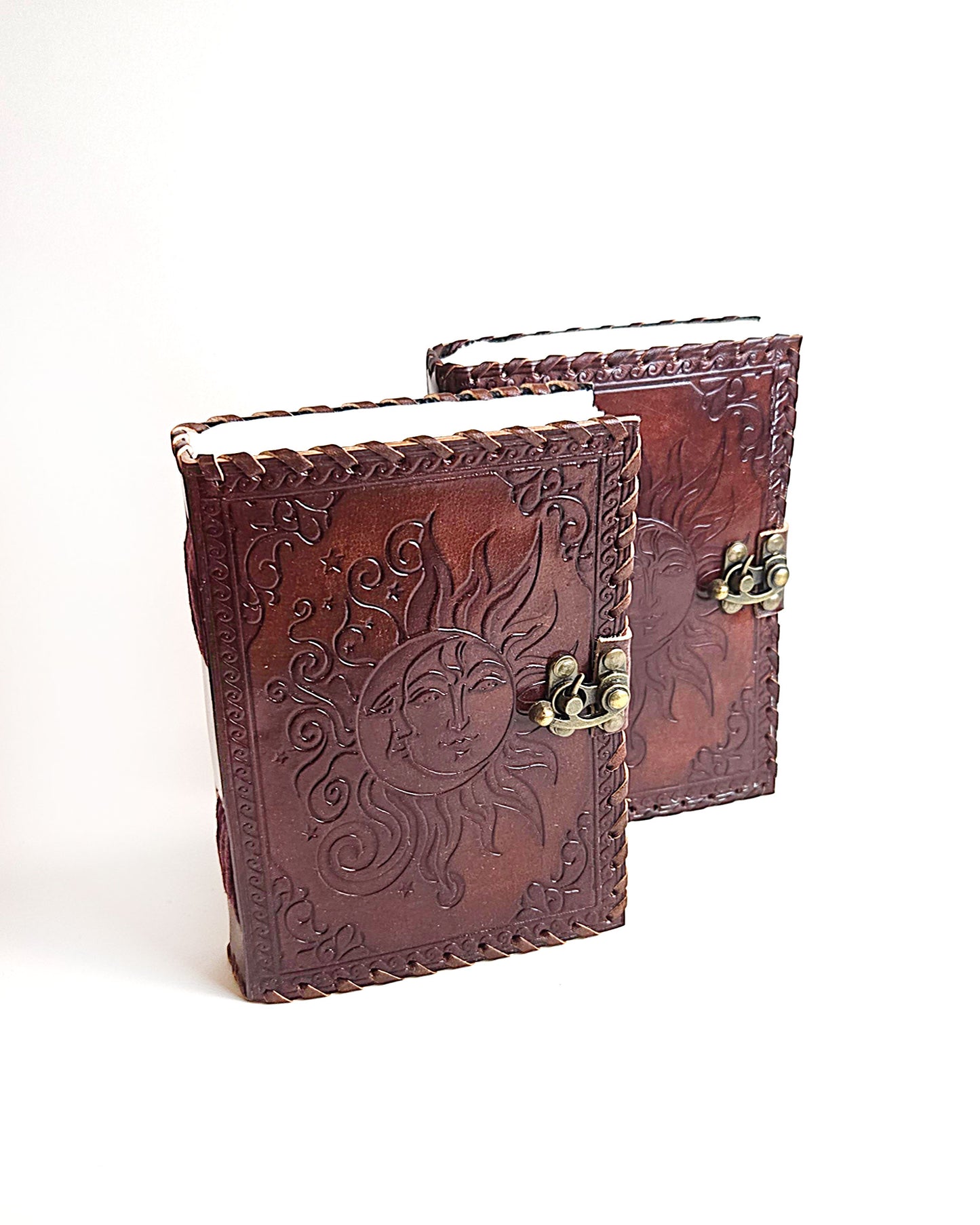 leather journals with embossed sun and moon design antique buckle closure and leather stitched edges front