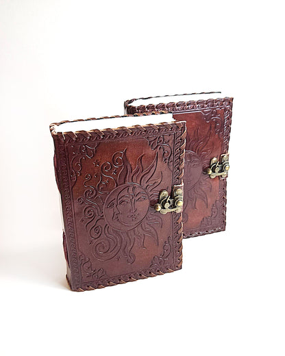 leather journals with embossed sun and moon design antique buckle closure and leather stitched edges front