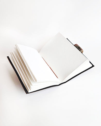 leather journal with embossed turtle design and antique buckle closure inside view